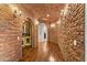 Hallway with wine cellar and brick accent wall at 21 E Oakwood Hills Dr, Chandler, AZ 85248