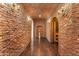 Hallway with brick accent wall and wine cellar alcove at 21 E Oakwood Hills Dr, Chandler, AZ 85248