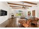 Bright living room with hardwood floors, fireplace, and wood beam ceiling at 21 E Oakwood Hills Dr, Chandler, AZ 85248