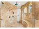 Spa-like shower room with travertine tile, bench, and a rainfall shower head at 21 E Oakwood Hills Dr, Chandler, AZ 85248