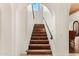 Elegant staircase featuring hardwood steps and white archways at 21 E Oakwood Hills Dr, Chandler, AZ 85248