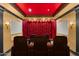 A home theater room with large screen, heavy curtains, and tiered seating at 21 E Oakwood Hills Dr, Chandler, AZ 85248