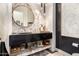 Elegant bathroom featuring a round mirror and marble tile at 21215 N 75Th St, Scottsdale, AZ 85255