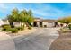 Luxury home exterior with a large driveway and manicured landscaping at 21215 N 75Th St, Scottsdale, AZ 85255