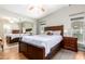 Main bedroom with wood furniture and mirrored closet doors at 2400 E Baseline Ave # 84, Apache Junction, AZ 85119