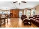 Living room with hardwood floors, leather furniture, and a wood wall unit at 2400 E Baseline Ave # 84, Apache Junction, AZ 85119