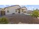 View of the backyard showing low-maintenance landscaping, covered patio, and surrounding block wall at 26706 N 174Th Ln, Surprise, AZ 85387