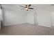 The bedroom is spacious and bright with hardwood floors and a modern ceiling fan at 26706 N 174Th Ln, Surprise, AZ 85387