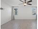 An airy bedroom with neutral walls, tile flooring, and two bright windows at 26706 N 174Th Ln, Surprise, AZ 85387