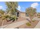 Inviting single-story home featuring desert landscaping, a tile roof, and a two-car garage at 26706 N 174Th Ln, Surprise, AZ 85387