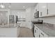 Modern kitchen with stainless steel appliances, granite countertops, and white cabinetry at 26706 N 174Th Ln, Surprise, AZ 85387