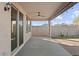 View of the covered patio featuring ceiling fan, concrete flooring, and views of backyard and perimeter wall at 26706 N 174Th Ln, Surprise, AZ 85387