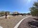 Community playground with swings and climbing structures for outdoor fun and recreation on a bright sunny day at 26706 N 174Th Ln, Surprise, AZ 85387