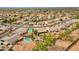 An aerial view showcases the putting green, covered patio, pool, and overall layout of the back yard at 3000 E Tulsa St, Gilbert, AZ 85295