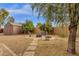 Private backyard showcasing a fire pit, seating area, and lush foliage, creating a serene outdoor retreat at 3000 E Tulsa St, Gilbert, AZ 85295