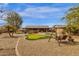 Spacious backyard featuring a putting green, hot tub, outdoor seating, and low-maintenance desert landscaping at 3000 E Tulsa St, Gilbert, AZ 85295