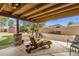 Backyard patio with wooden chairs, lush lawn, and an open space surrounded by a block fence for privacy at 3000 E Tulsa St, Gilbert, AZ 85295