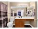 Neutral bathroom featuring a single vanity, large mirror, and decorative shower curtain at 3000 E Tulsa St, Gilbert, AZ 85295