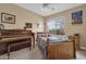 Cozy bedroom featuring a wooden bed frame, neutral walls, a window, and a piano at 3000 E Tulsa St, Gilbert, AZ 85295