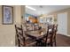 Stylish dining room with hardwood floors, a large table, and a view into the kitchen at 3000 E Tulsa St, Gilbert, AZ 85295