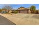 Single-story home boasting a large driveway and desert-style landscaping in the front yard at 3000 E Tulsa St, Gilbert, AZ 85295