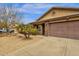 Cozy home showcasing stone accents, a desert-themed front yard, and a spacious garage at 3000 E Tulsa St, Gilbert, AZ 85295