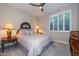 Cozy bedroom featuring neutral tones, plantation shutters, and stylish décor at 30343 N 130Th Dr, Peoria, AZ 85383