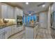 Modern kitchen featuring white cabinets, an island, and stainless steel double ovens at 30343 N 130Th Dr, Peoria, AZ 85383