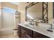 Bathroom with dark vanity and decorative mirror at 31689 N 128Th Dr, Peoria, AZ 85383