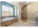 Relaxing bathroom with soaking tub and walk-in shower at 31689 N 128Th Dr, Peoria, AZ 85383