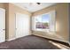 Bedroom with white doors and a window with shutters at 31689 N 128Th Dr, Peoria, AZ 85383