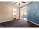 Bedroom with two-toned walls, carpet flooring, and access to a large closet at 31689 N 128Th Dr, Peoria, AZ 85383