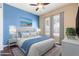 Bedroom with ceiling fan, neutral decor, and white plantation shutters allowing for a bright, airy ambiance at 31689 N 128Th Dr, Peoria, AZ 85383