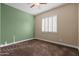 Bedroom with green accent wall and window with shutters at 31689 N 128Th Dr, Peoria, AZ 85383