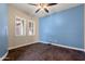 Bright bedroom with two windows, neutral walls, and plush carpeting at 31689 N 128Th Dr, Peoria, AZ 85383