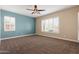 Spacious bedroom with neutral carpeting and window shutters at 31689 N 128Th Dr, Peoria, AZ 85383