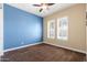 Bedroom featuring a ceiling fan and window with shutters at 31689 N 128Th Dr, Peoria, AZ 85383