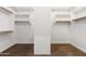 Large walk-in closet with built-in shelves and rods at 31689 N 128Th Dr, Peoria, AZ 85383