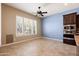 Bright kitchen with tile flooring, large window, and ceiling fan at 31689 N 128Th Dr, Peoria, AZ 85383