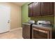 Laundry room with washer, dryer and upper cabinets at 31689 N 128Th Dr, Peoria, AZ 85383