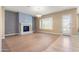 Living room featuring a marble fireplace, hardwood floors and large windows at 31689 N 128Th Dr, Peoria, AZ 85383