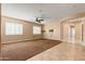 Large living room with tile and carpet flooring at 31689 N 128Th Dr, Peoria, AZ 85383