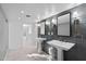 Elegant bathroom with double pedestal sinks and gray tile at 3174 E Marlette Ave, Phoenix, AZ 85016