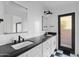 Modern bathroom with double vanity, black fixtures, and a walk-in shower at 3174 E Marlette Ave, Phoenix, AZ 85016