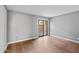 Bright bedroom with wood-look flooring and sliding glass door to patio at 3174 E Marlette Ave, Phoenix, AZ 85016