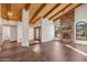 Living room boasts a stone fireplace, hardwood floors, and high ceilings with wood beams at 3174 E Marlette Ave, Phoenix, AZ 85016