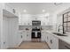 Modern kitchen with white cabinets, quartz counters, and stainless steel appliances at 3491 N Arizona Ave # 98, Chandler, AZ 85225