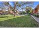 Green grassy courtyard with a pathway, trees, and pool at 355 E Thomas Rd # B206, Phoenix, AZ 85012