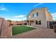 Artificial turf backyard with a covered patio and fire pit at 3702 W Naomi Ln, San Tan Valley, AZ 85144