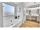 Elegant bathroom with double vanity and soaking tub at 3702 W Naomi Ln, San Tan Valley, AZ 85144